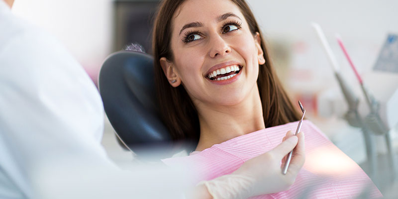 woman-smiling-in-dental-chair-for-exam-periodontics
